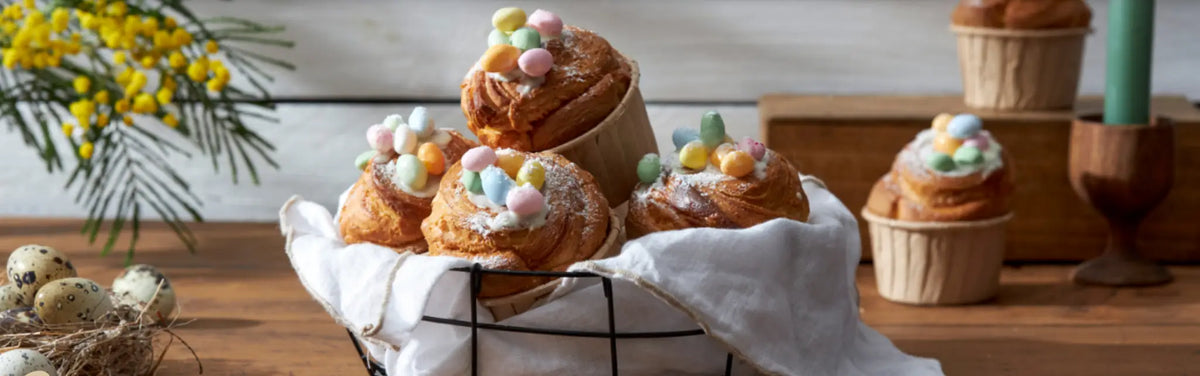 Easter cruffin pastries topped with icing and mini eggs on a festive brunch table