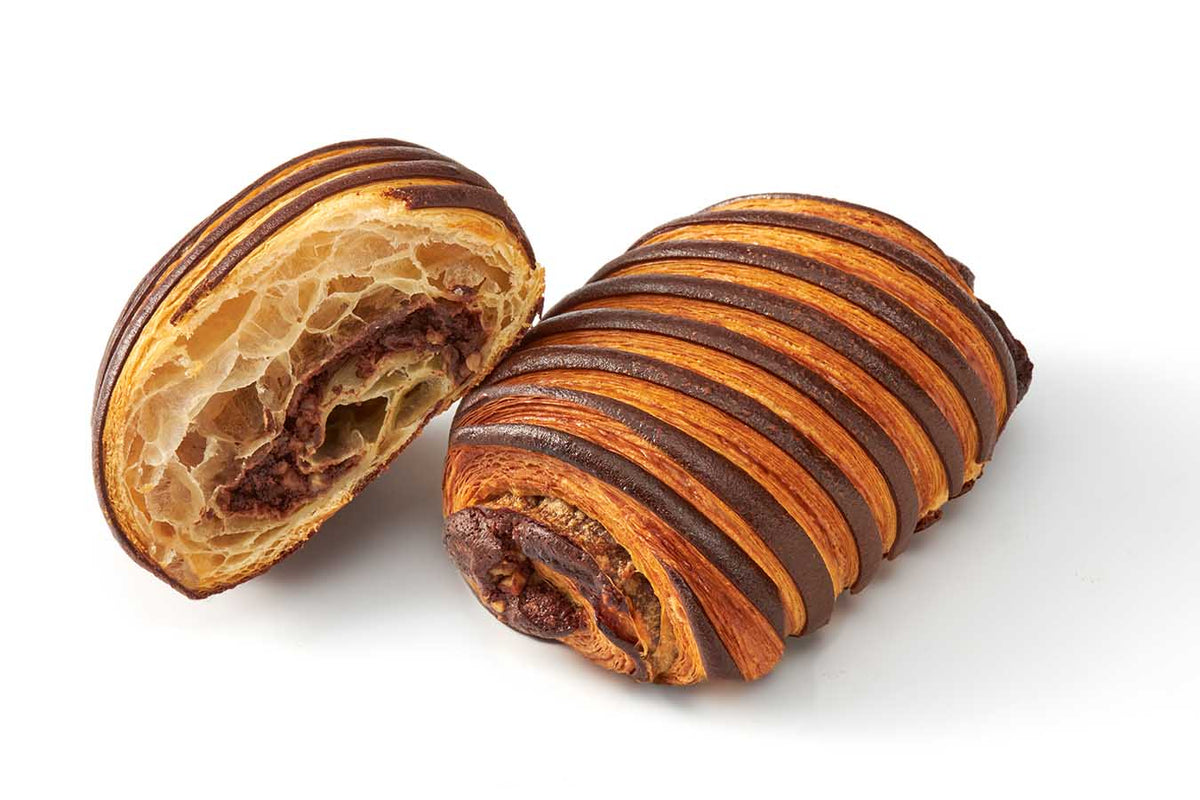 Premium Chocolate Hazelnut Roll with cocoa and classic dough stripes, sliced to reveal chocolate hazelnut filling