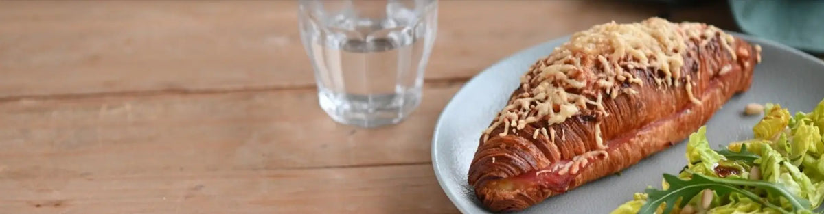 Délifrance ham and cheese croissant served with fresh green salad in a Singapore home setting