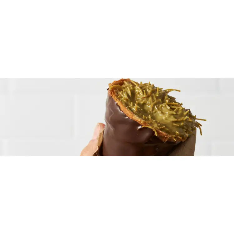 Dubai croissant with dark chocolate coating and pistachio-kadaif filling, styled for Singapore foodservice