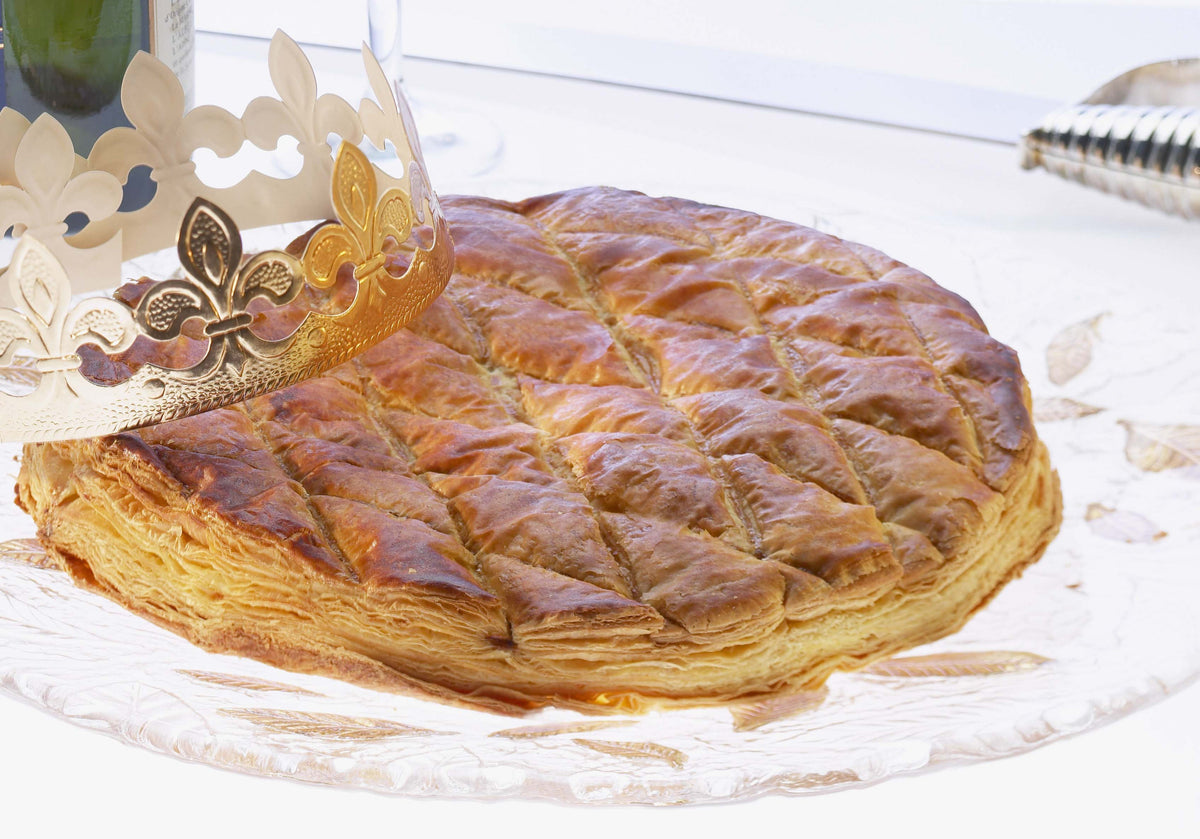 Galette des rois kings cake with golden crown and slice – traditional French Epiphany pastry