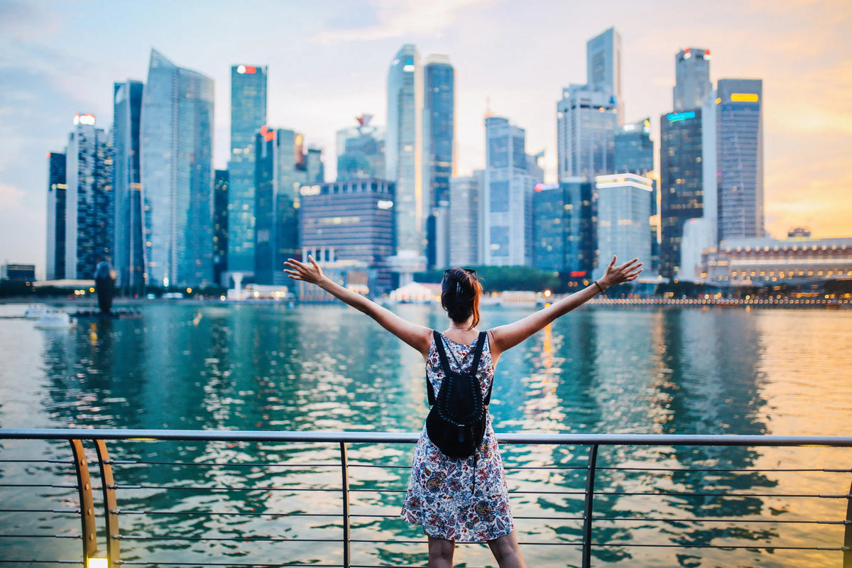 Woman celebrating National Day at Marina Bay with Singapore skyline in the background