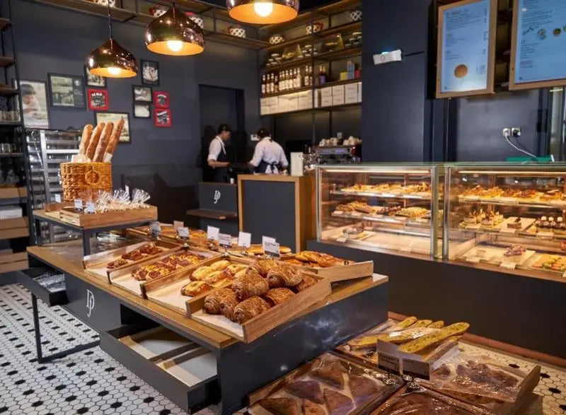 Retail bakery display with assorted bread and pastries shown for Delifrance Singapore Wholesale.