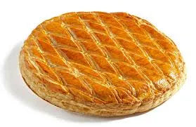 Scored galette des rois kings cake showing puff pastry layers and traditional French design
