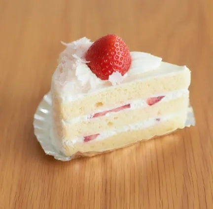Strawberry shortcake styled with clean cross-section, fresh fruit garnish, and minimalist plating — a food styling example that helps improve bakery business appeal.