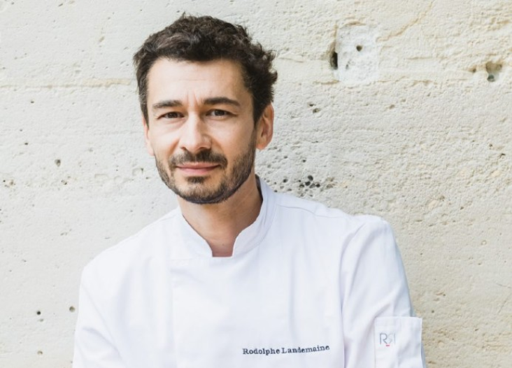 Chef Rodolphe Landemaine in a white chef's coat, known for his expertise in artisanal baking and Délifrance creations